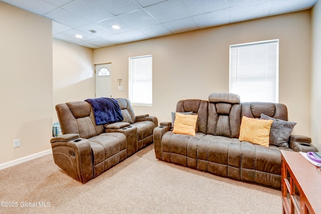 living room with carpet floors and a paneled ceiling