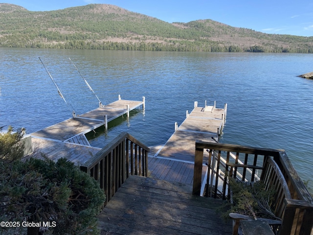 view of dock featuring a water and mountain view