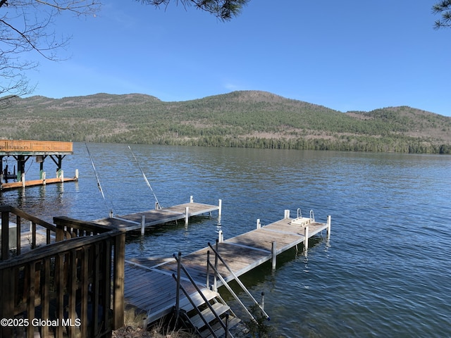 view of dock featuring a water and mountain view