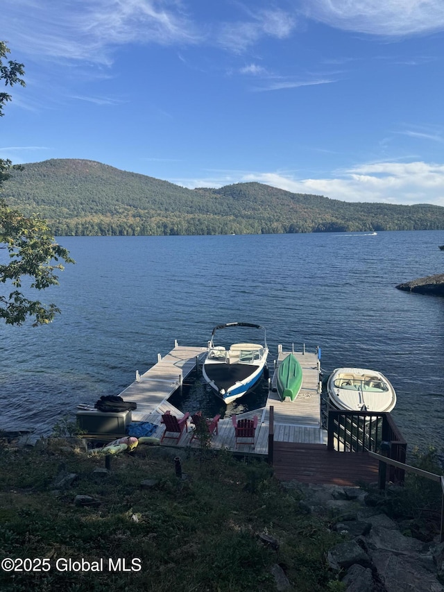 view of dock with a water and mountain view