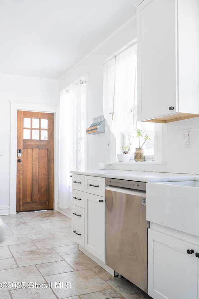 kitchen featuring white cabinets, a wealth of natural light, light countertops, and dishwasher