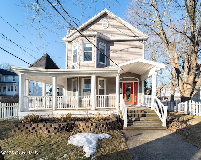 view of front of property with a porch and fence