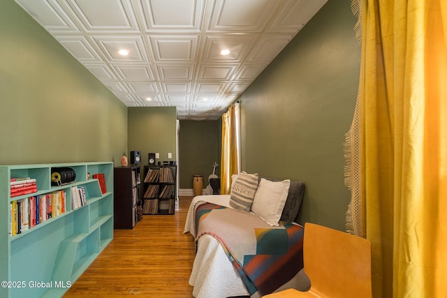 living area with wood finished floors and an ornate ceiling