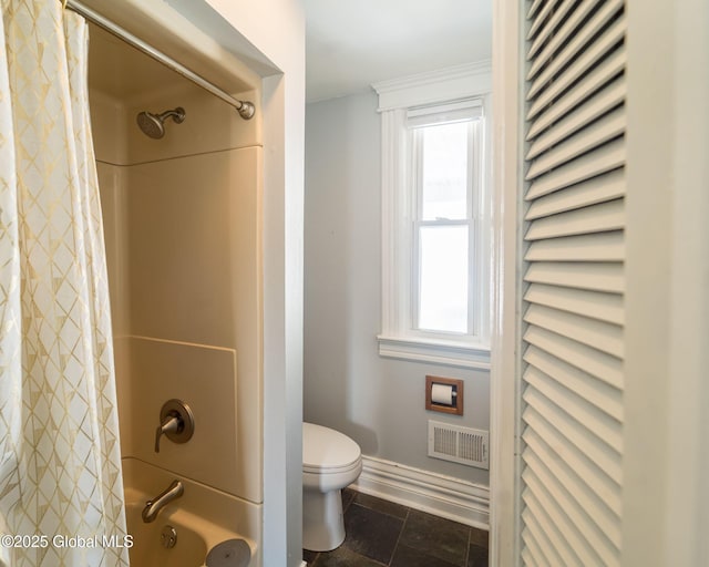 bathroom featuring toilet, baseboards, visible vents, and shower / bathtub combination with curtain