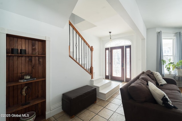 entryway with stairway and light tile patterned floors