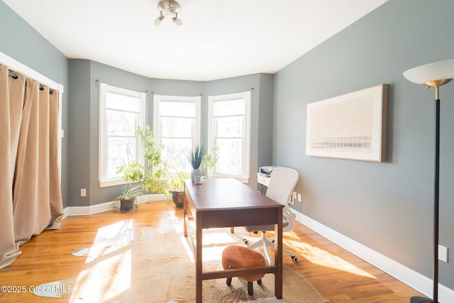 office area with wood finished floors and baseboards