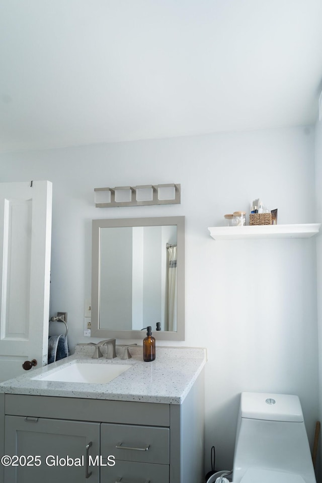 full bath featuring toilet and vanity