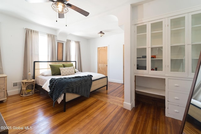 bedroom featuring baseboards, visible vents, and hardwood / wood-style floors