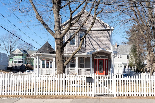 view of front of house featuring a porch and a fenced front yard