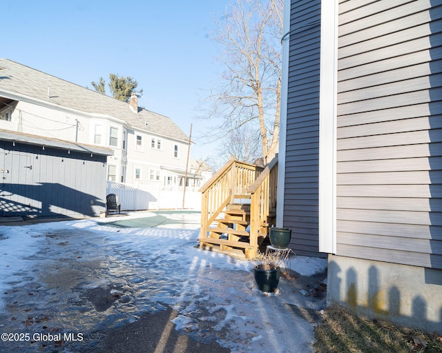 view of yard featuring fence, stairway, an outdoor structure, and a storage shed