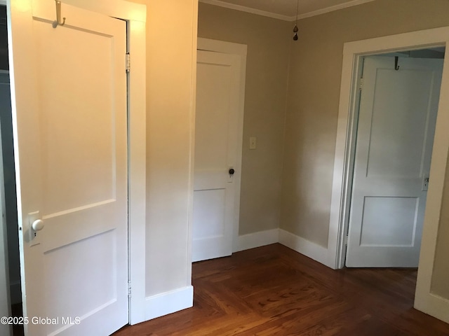 corridor with crown molding and dark parquet flooring