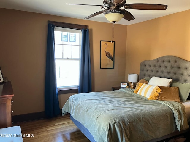 bedroom with hardwood / wood-style flooring and ceiling fan