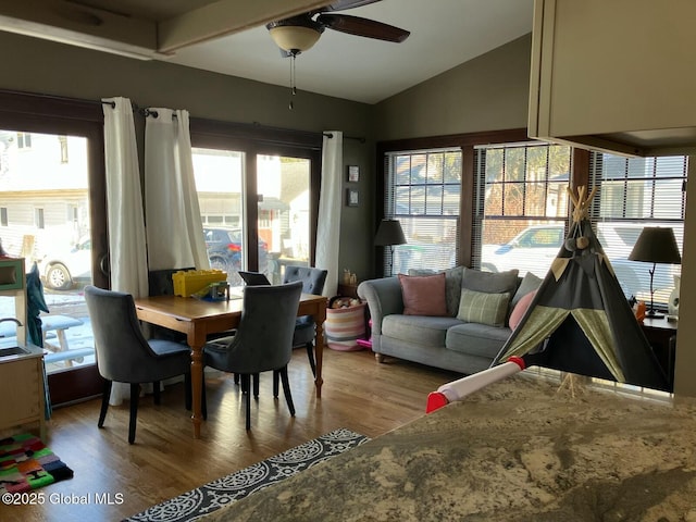 dining space with hardwood / wood-style flooring, lofted ceiling, and ceiling fan