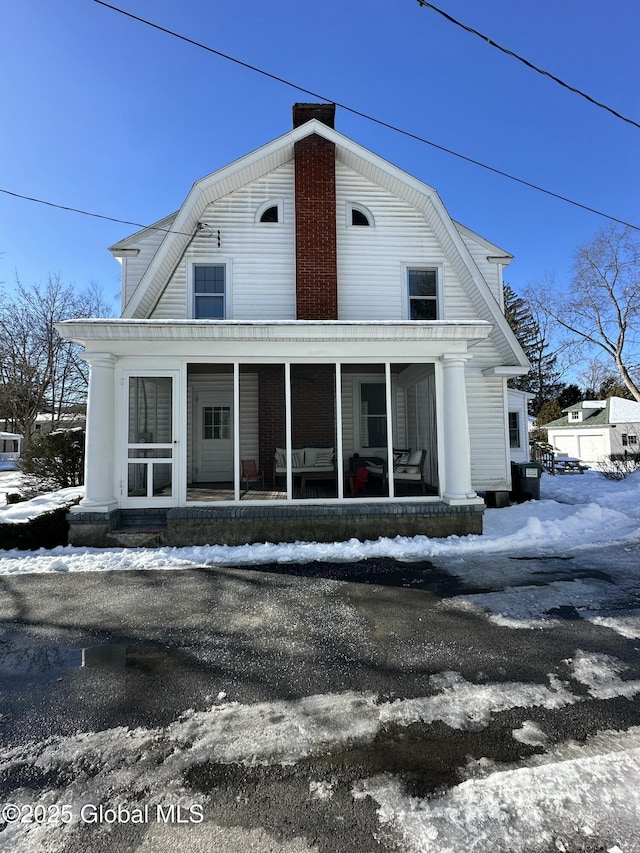 view of snow covered rear of property