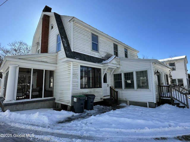 view of front of home with a sunroom