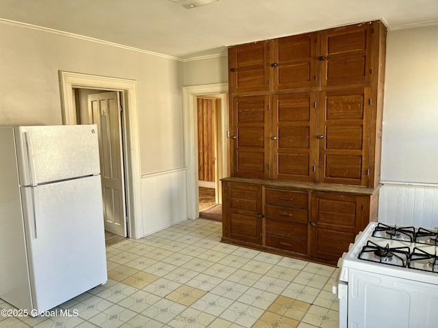 kitchen featuring white appliances and ornamental molding