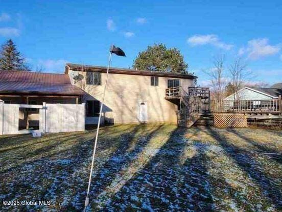 back of property featuring a deck