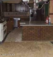 kitchen with double oven range and dark brown cabinets