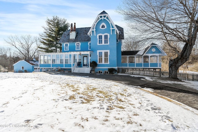 view of front of property with a sunroom