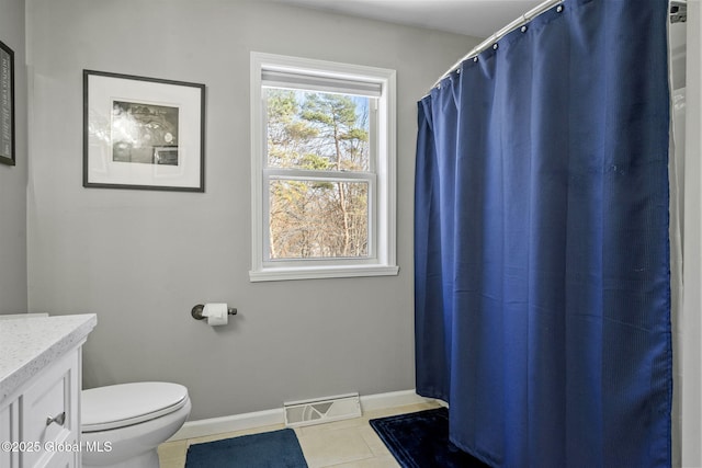 bathroom featuring vanity, tile patterned floors, and toilet