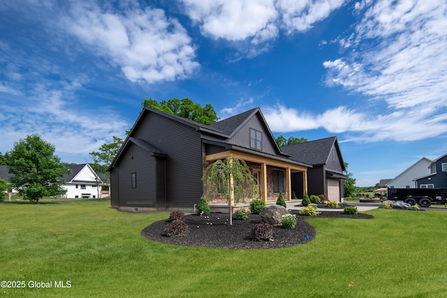 view of home's exterior with a garage, covered porch, and a lawn