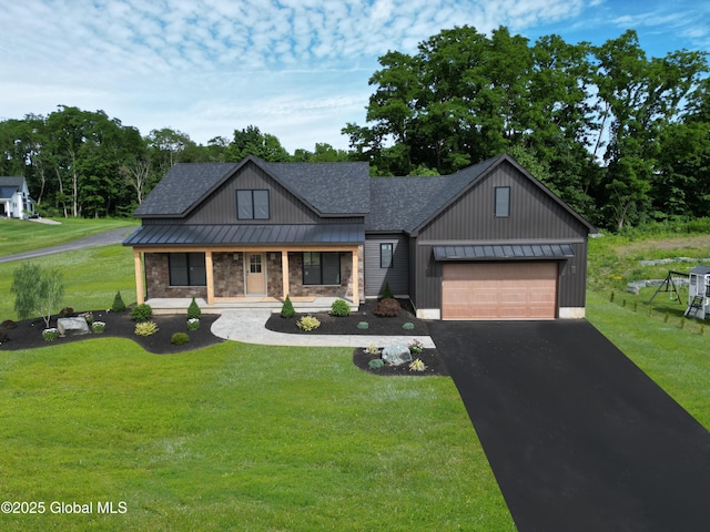 view of front of home with a garage, a front yard, and covered porch