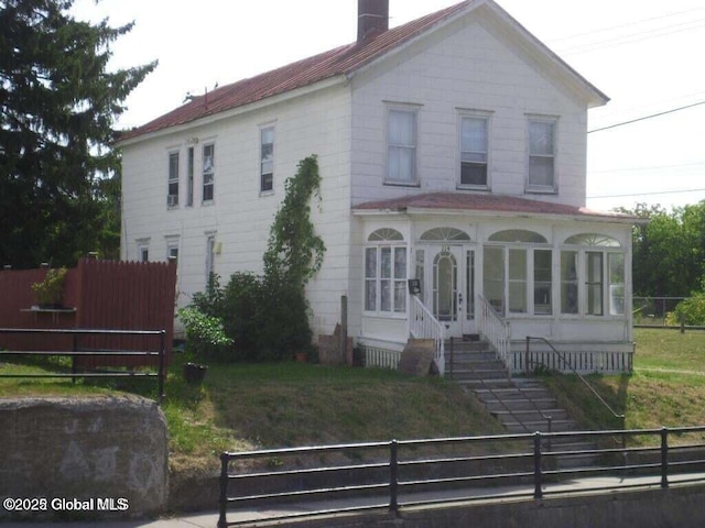 view of front of property with a sunroom