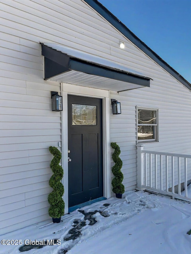 view of snow covered property entrance