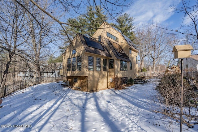 view of snow covered back of property