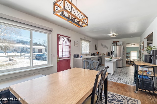 dining space with plenty of natural light, sink, and hardwood / wood-style floors