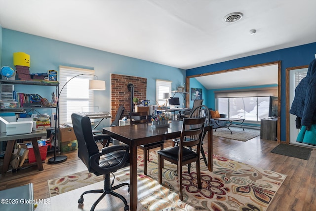 office with lofted ceiling and hardwood / wood-style floors