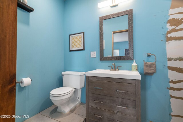 bathroom with vanity, toilet, and tile patterned flooring