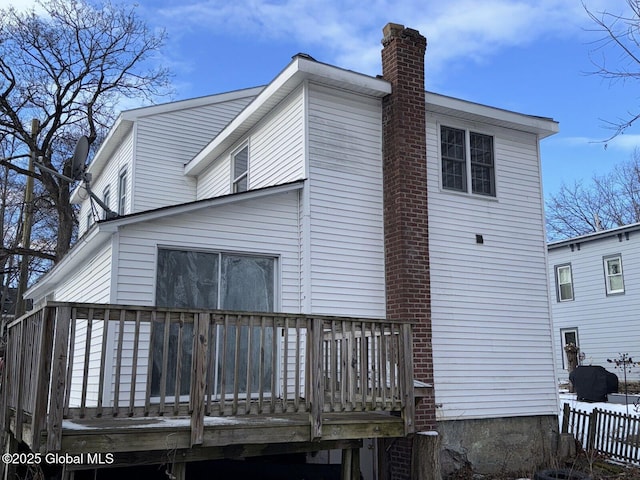 rear view of house featuring a wooden deck