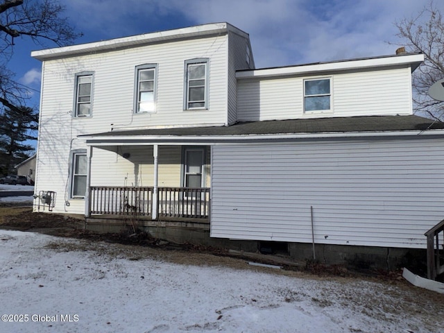 back of property with a porch