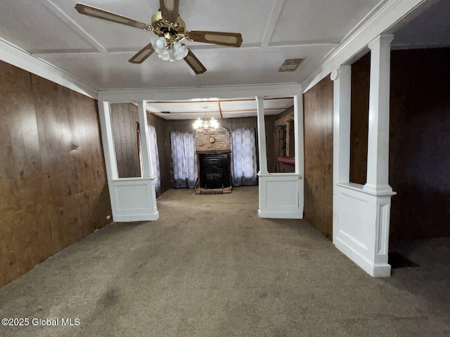 interior space featuring wood walls, ceiling fan, and carpet flooring