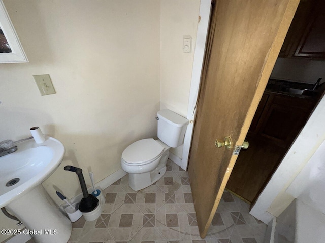 bathroom with tile patterned flooring, sink, and toilet