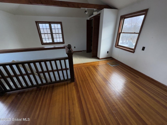 interior space with hardwood / wood-style flooring and lofted ceiling