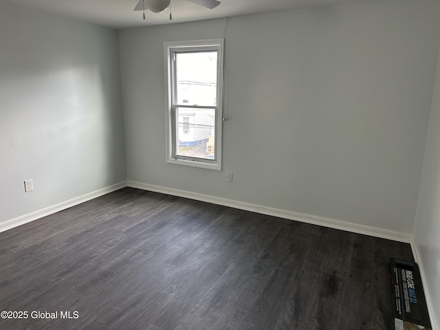 spare room featuring dark hardwood / wood-style floors and ceiling fan