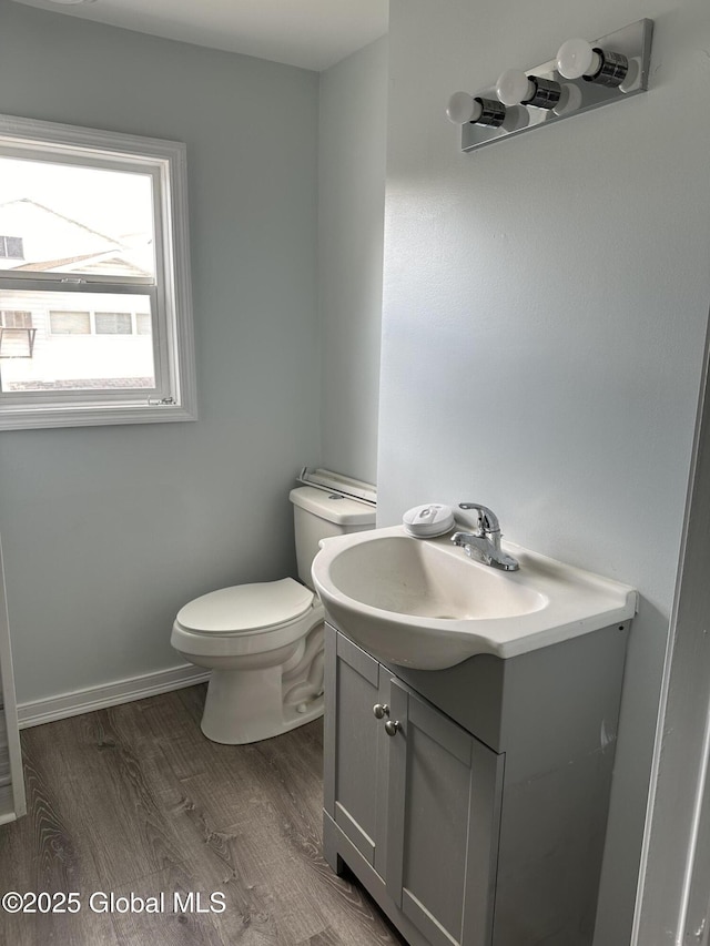 bathroom featuring vanity, hardwood / wood-style floors, and toilet