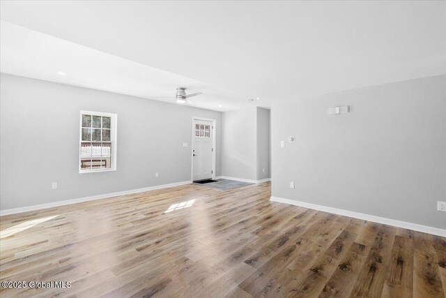 spare room featuring ceiling fan and light wood-type flooring