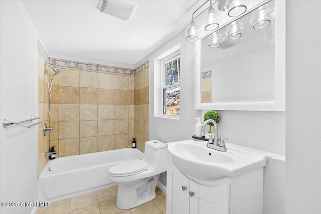 full bathroom with vanity, tiled shower / bath combo, tile patterned floors, and toilet