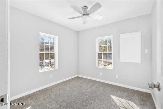 carpeted spare room with ceiling fan