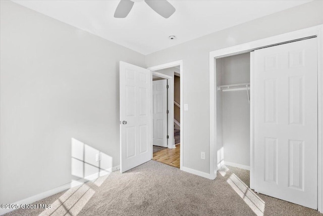 unfurnished bedroom with ceiling fan, a closet, and light carpet