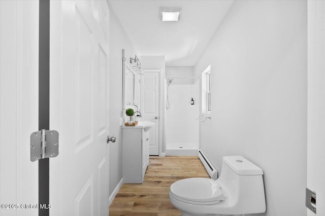 bathroom with toilet, a shower, a baseboard radiator, vanity, and hardwood / wood-style flooring