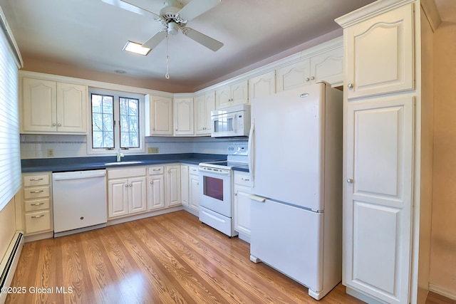 kitchen featuring sink, light wood-type flooring, baseboard heating, ceiling fan, and white appliances