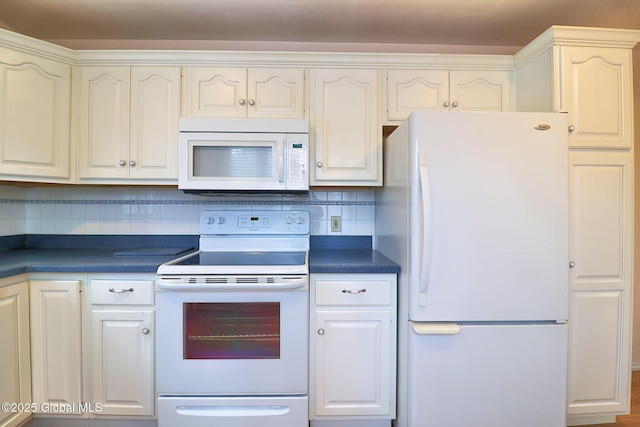 kitchen featuring tasteful backsplash and white appliances