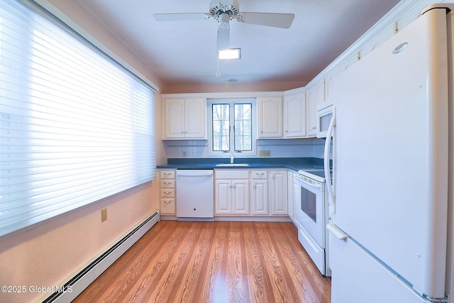 kitchen with white appliances, light hardwood / wood-style flooring, baseboard heating, white cabinetry, and backsplash