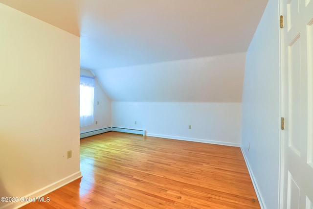 bonus room with lofted ceiling, light hardwood / wood-style flooring, and baseboard heating