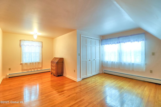 bonus room featuring lofted ceiling, a baseboard radiator, and wood-type flooring