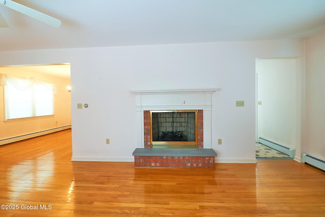 unfurnished living room with a baseboard radiator, a fireplace, and light hardwood / wood-style flooring